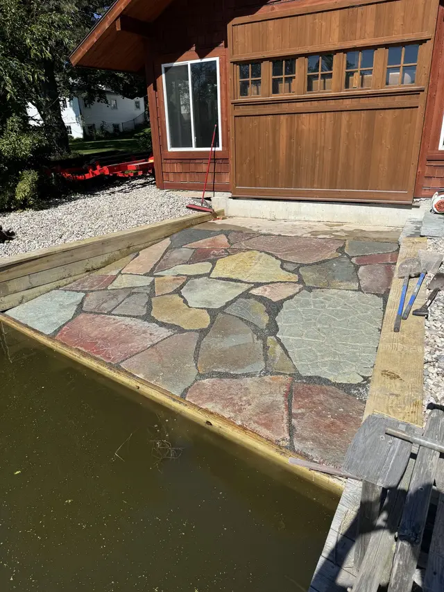 Flagstone patio next to a house