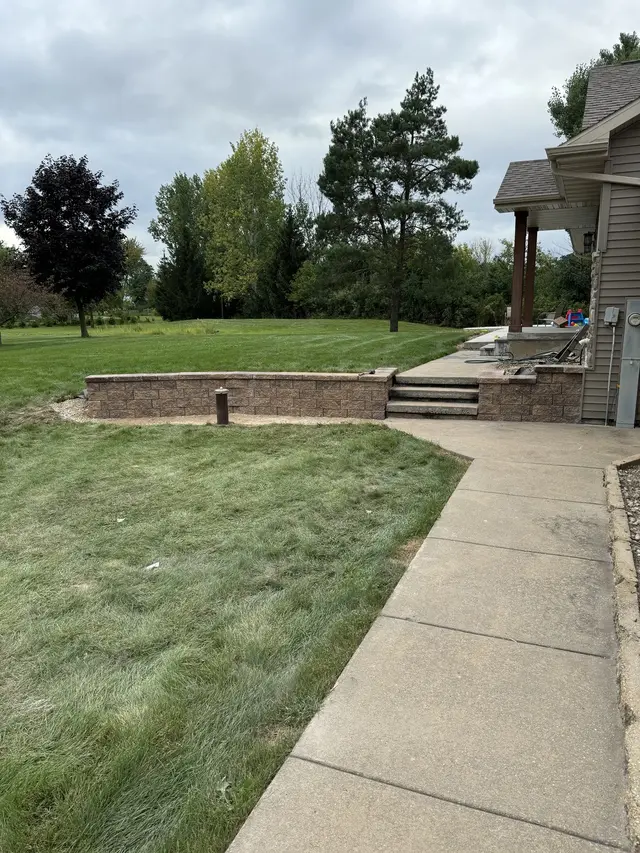Green lawn along a walkway to a house