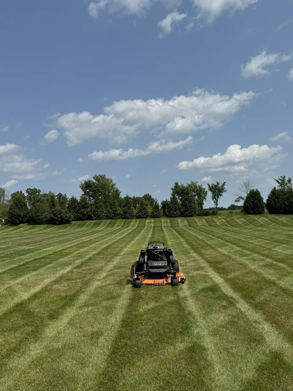 Zero-turn mower on a striped lawn