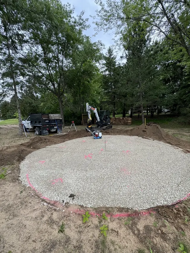 Gravel base prepared for a round patio