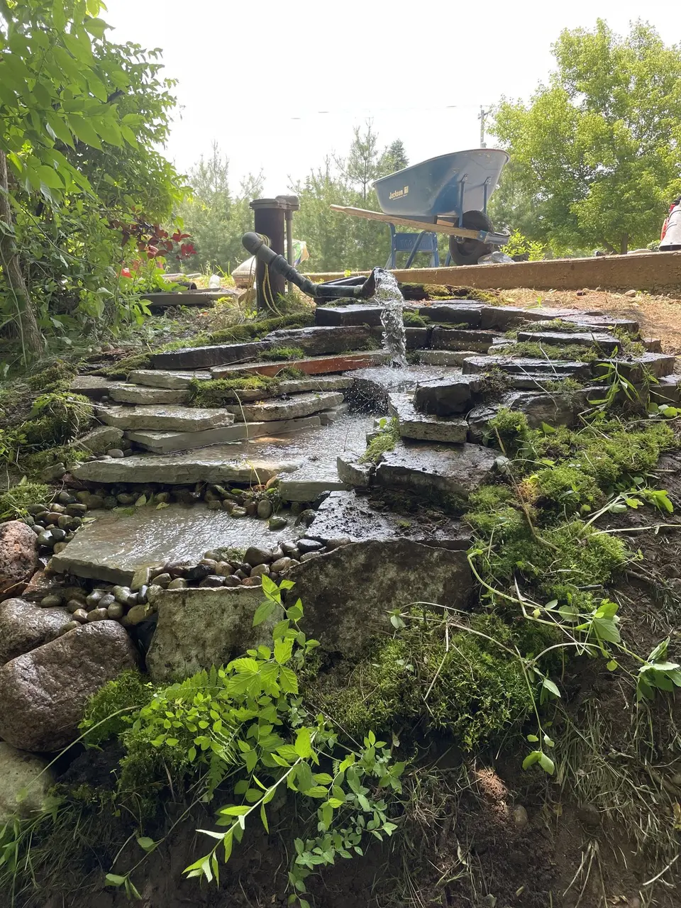 Stone waterfall and pond with plantings
