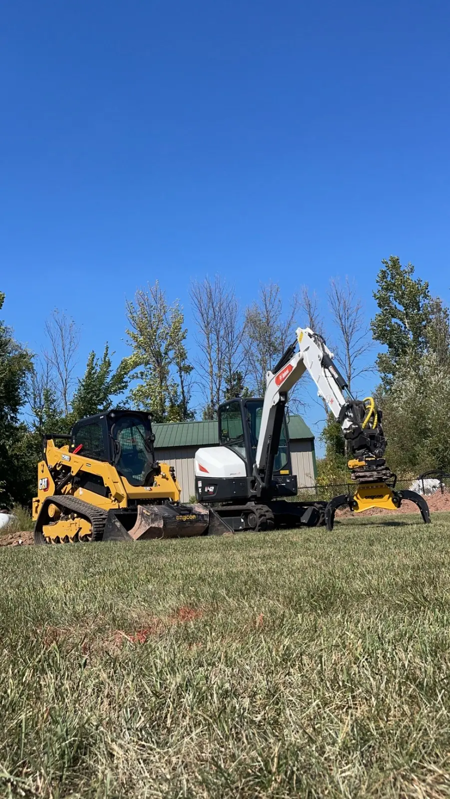 Skid steer and excavator on a job site
