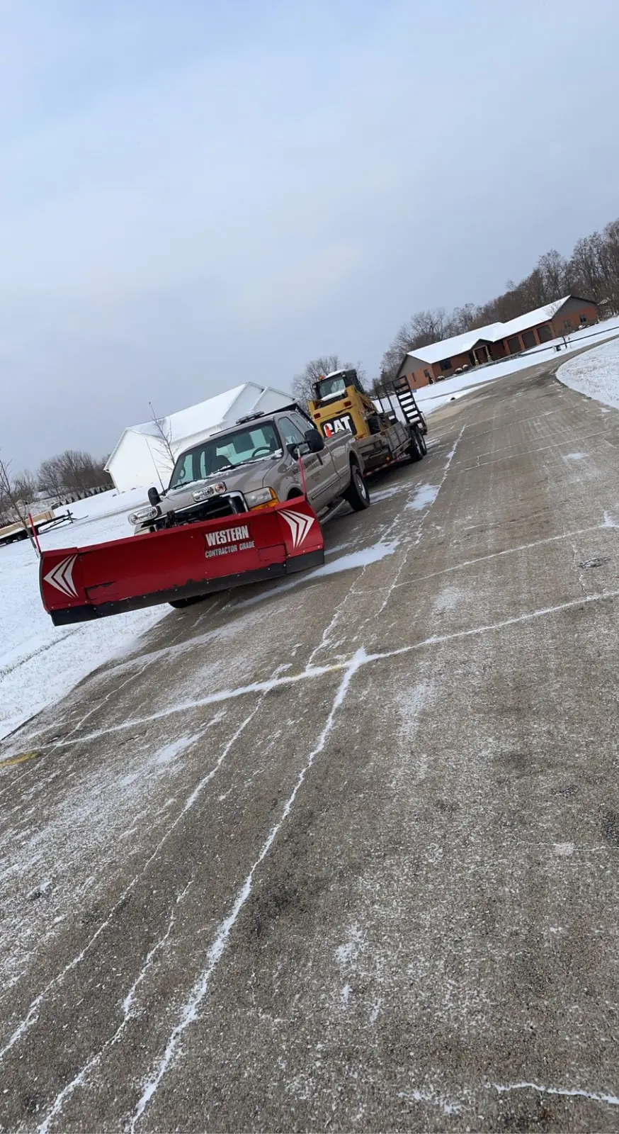 Plow truck clearing snow from a parking lot