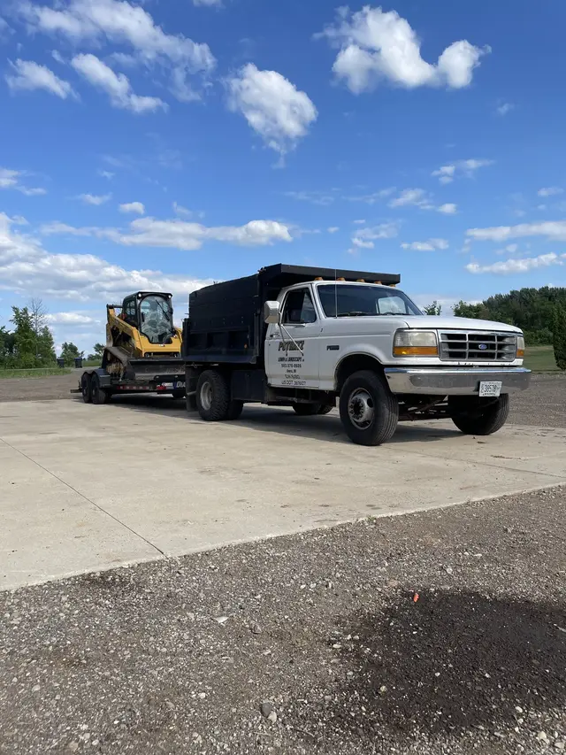 Dump truck with an equipment trailer